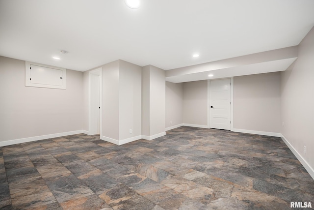 finished basement with recessed lighting, stone finish flooring, and baseboards