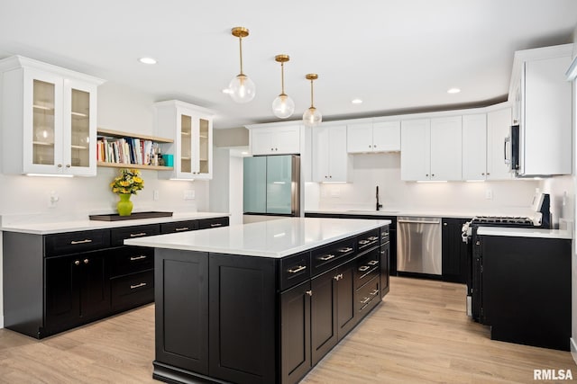 kitchen featuring a sink, dark cabinetry, stainless steel appliances, and white cabinetry
