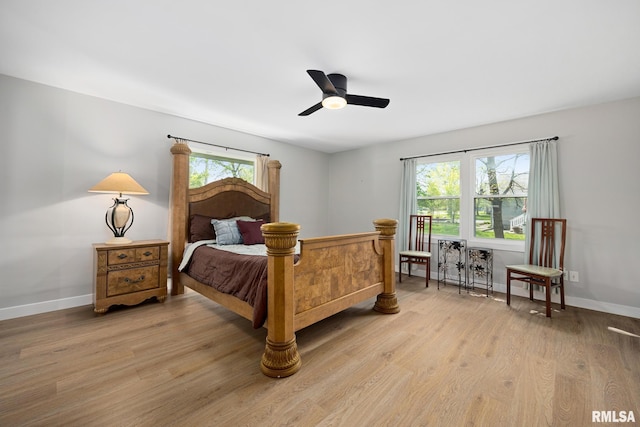 bedroom with baseboards, light wood-style flooring, and ceiling fan
