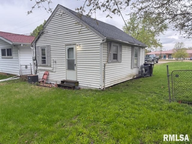 3336 N Sterling Ave, Peoria, IL 61604 - back of house featuring a lawn, roof with shingles, fence, and entry steps