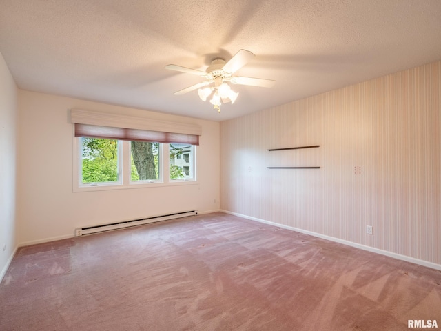 empty room featuring carpet floors, a textured ceiling, ceiling fan, and a baseboard heating unit