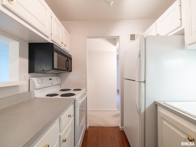 kitchen with visible vents, white appliances, light countertops, white cabinetry, and dark wood finished floors