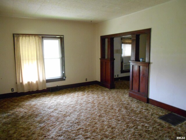 empty room featuring baseboards, carpet, and visible vents