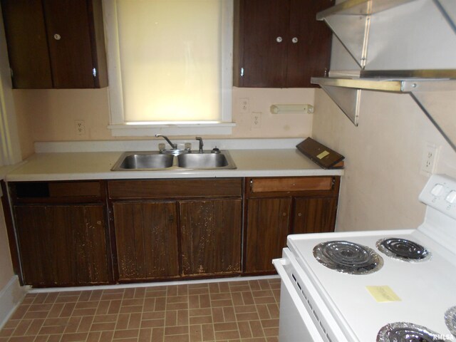 kitchen with dark brown cabinetry, a sink, light countertops, white electric range oven, and extractor fan