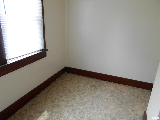 unfurnished bedroom with baseboards and light carpet