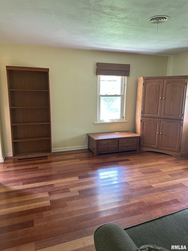 unfurnished bedroom with baseboards and wood finished floors