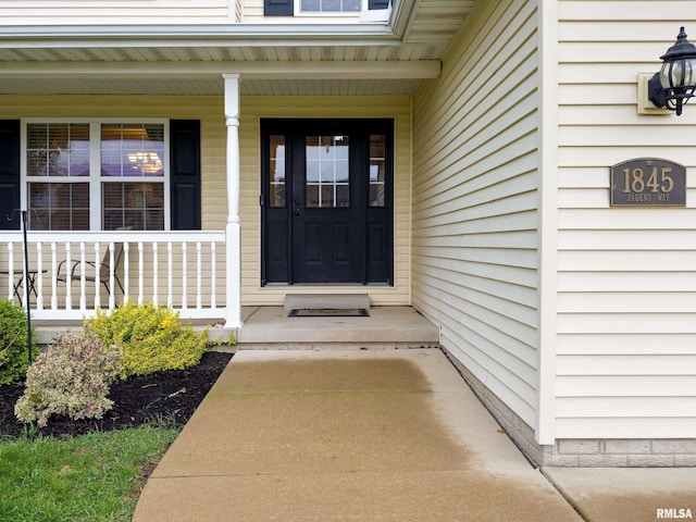 doorway to property featuring covered porch