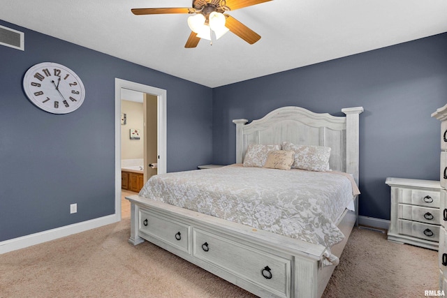 bedroom with ceiling fan, visible vents, baseboards, connected bathroom, and light carpet