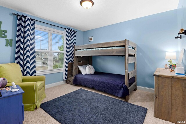 carpeted bedroom featuring baseboards