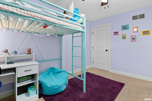 bedroom featuring visible vents, baseboards, ceiling fan, and light carpet