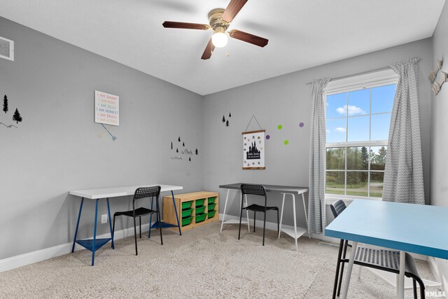 office space featuring baseboards, a ceiling fan, carpet floors, and visible vents