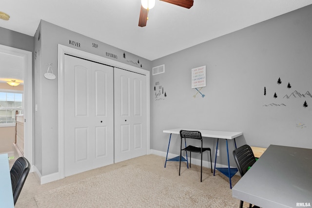 carpeted office with a ceiling fan, baseboards, and visible vents