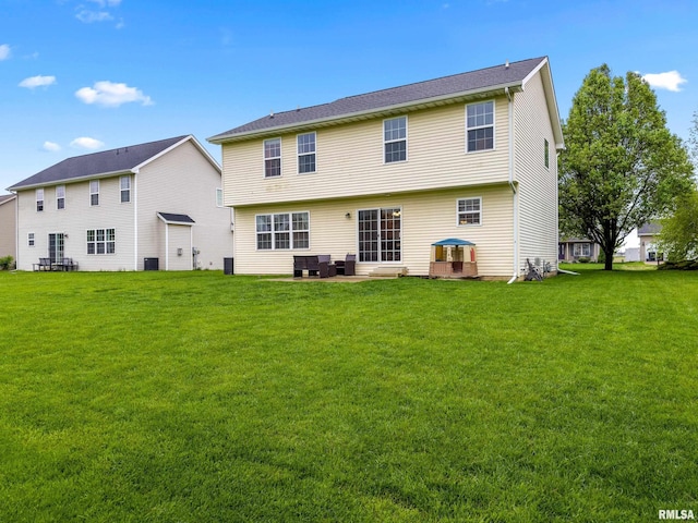 back of property featuring a lawn, central AC, and a patio area