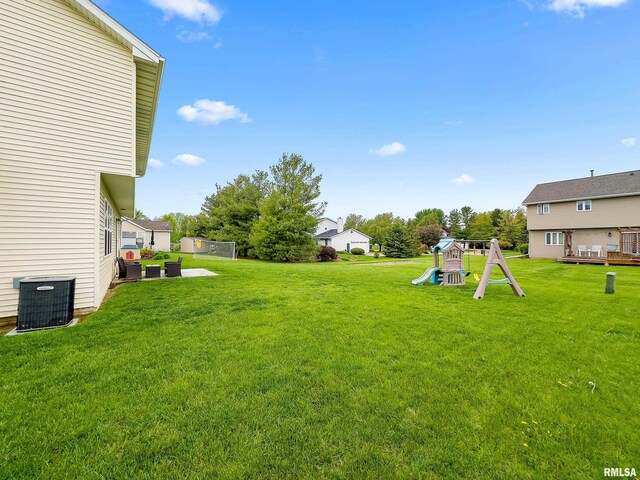 view of yard featuring cooling unit and a playground
