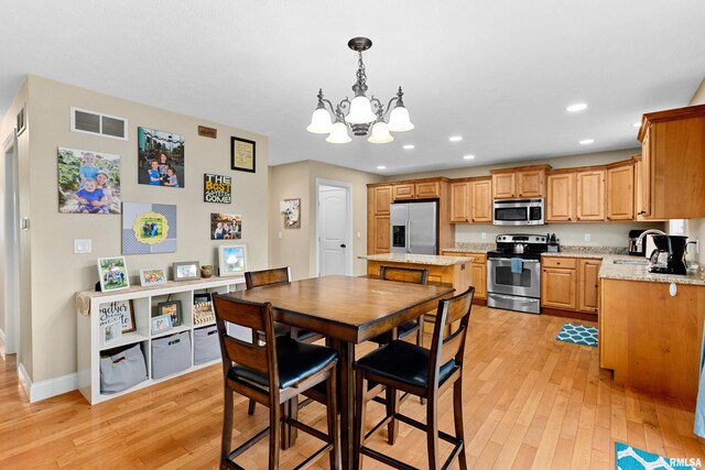 dining room featuring visible vents, light wood-style floors, baseboards, recessed lighting, and a chandelier