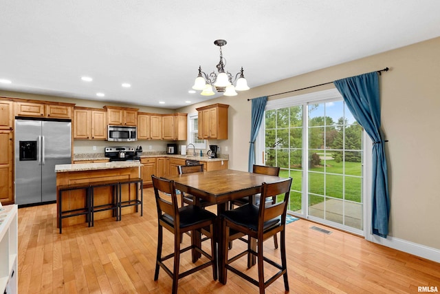 dining area with an inviting chandelier, light wood-type flooring, recessed lighting, and visible vents