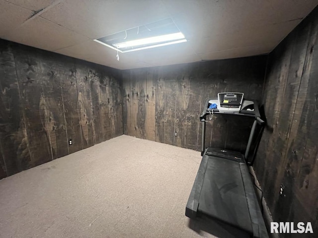 exercise room featuring wood walls