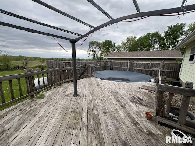 wooden terrace with a fenced backyard and a jacuzzi