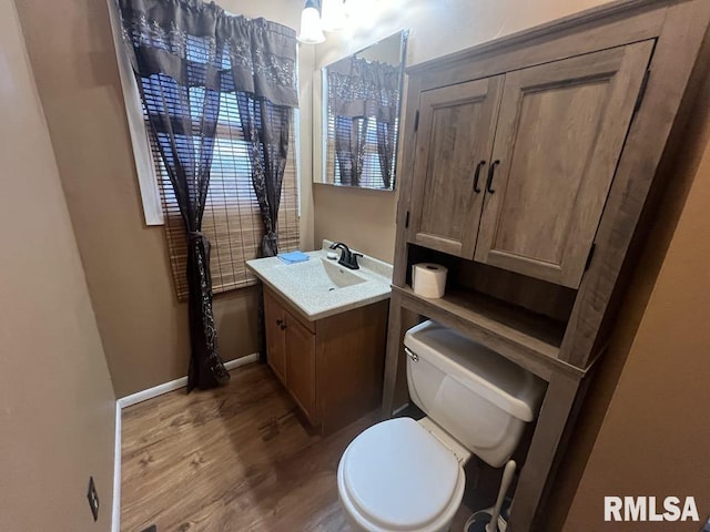 bathroom featuring vanity, toilet, and wood finished floors