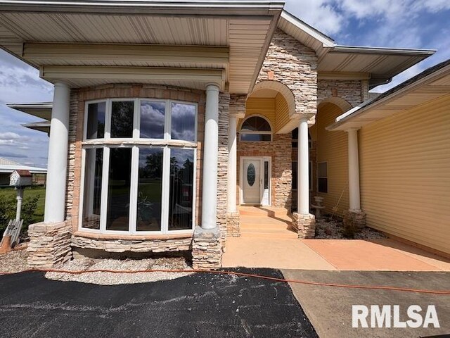 24211 N Carver Rd, Canton, IL 61520 - doorway to property featuring stone siding