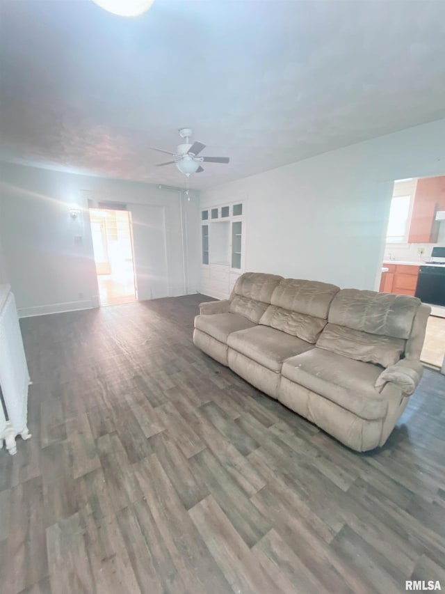 301 Cortland Ave, Avon, IL 61415 - living room with wood finished floors, ceiling fan, plenty of natural light, and baseboards