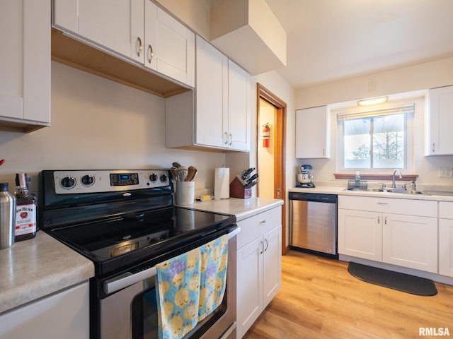 kitchen with a sink, light countertops, and stainless steel appliances