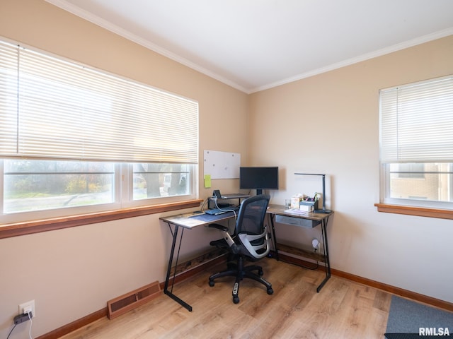 office area with baseboards, ornamental molding, wood finished floors, and visible vents