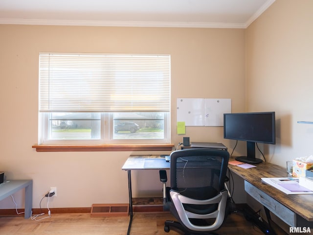 office space with crown molding, wood finished floors, visible vents, and a wealth of natural light