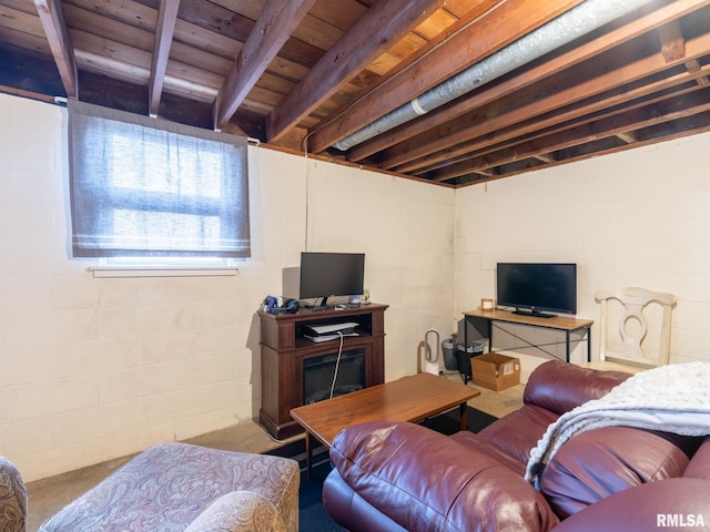 living area featuring wood ceiling, concrete flooring, beam ceiling, and concrete block wall