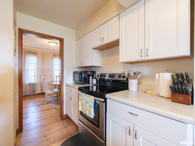 kitchen featuring light wood-style floors, light countertops, white cabinetry, and stainless steel appliances