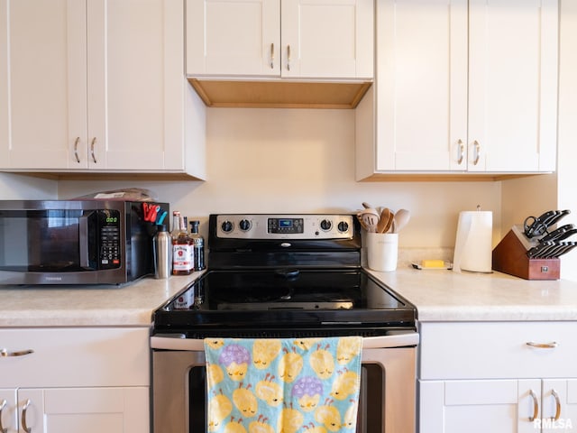 kitchen featuring light countertops, appliances with stainless steel finishes, and white cabinets
