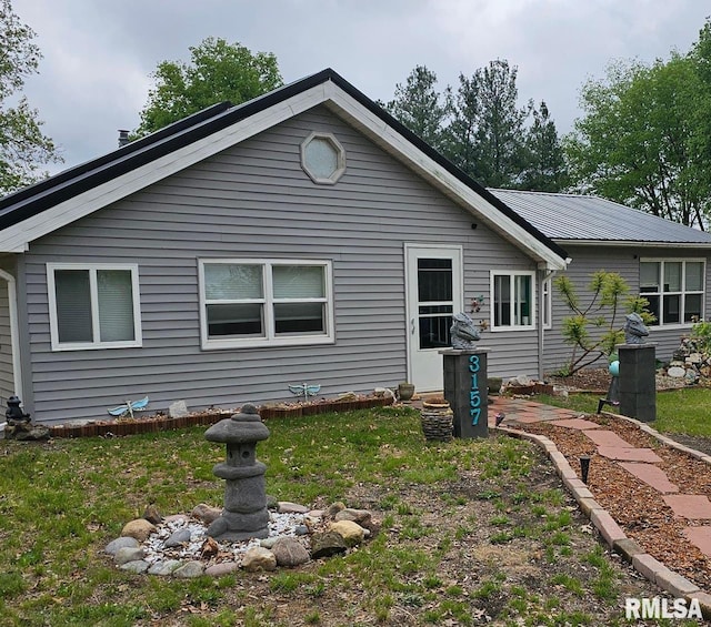 back of property with a yard