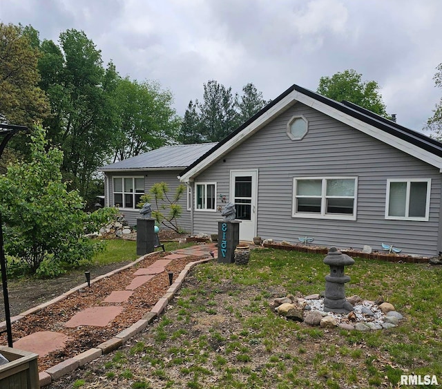 rear view of house with metal roof