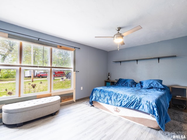 bedroom featuring a ceiling fan and wood finished floors