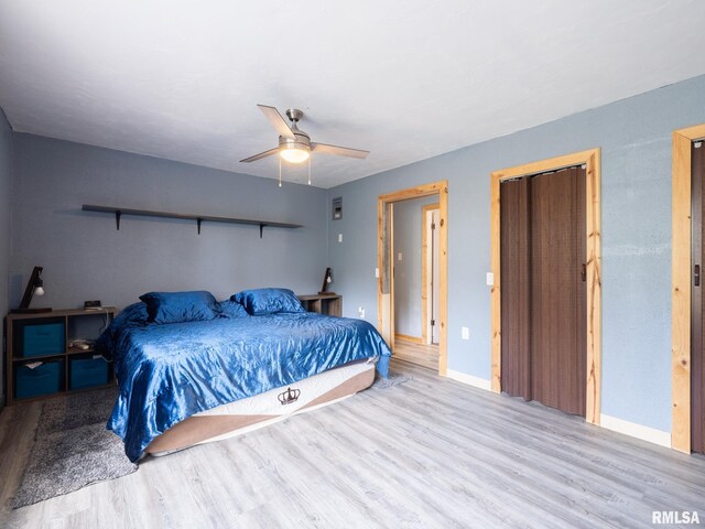 bedroom with wood finished floors, baseboards, and ceiling fan