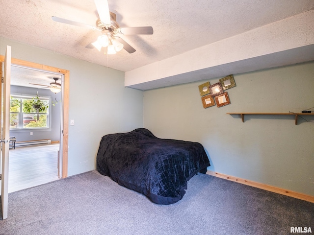 carpeted bedroom with a baseboard heating unit, a ceiling fan, and a textured ceiling