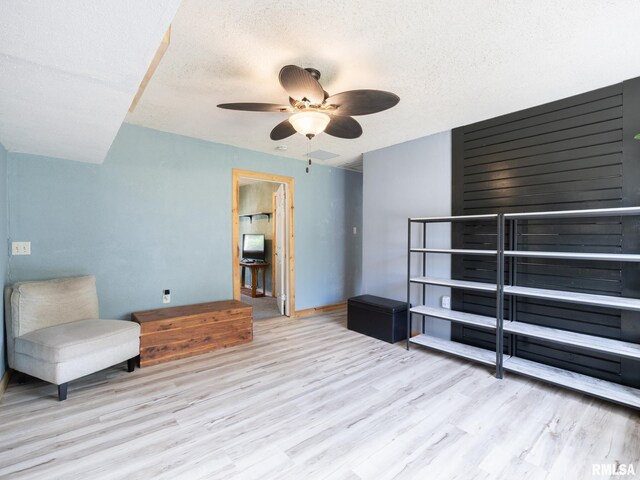 unfurnished room featuring a ceiling fan, a textured ceiling, and wood finished floors