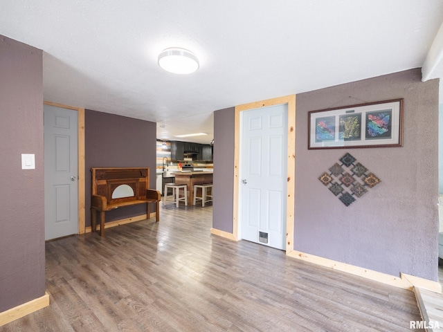 interior space with baseboards and wood finished floors