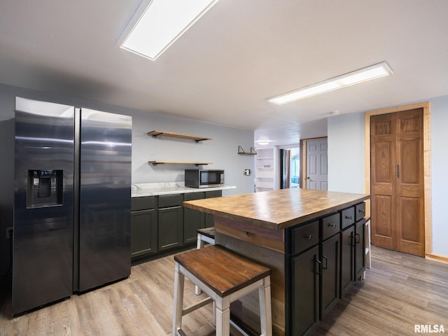 kitchen featuring open shelves, stainless steel appliances, wooden counters, and light wood-type flooring