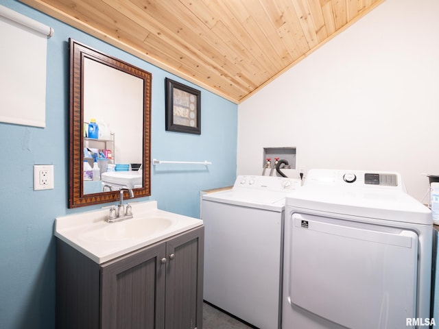 laundry room featuring separate washer and dryer, wooden ceiling, cabinet space, and a sink