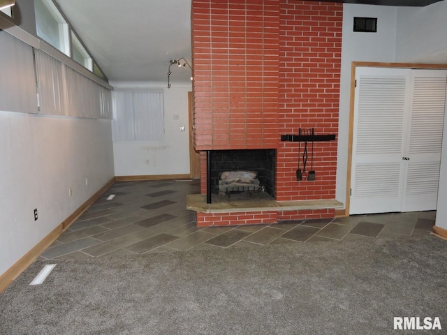 unfurnished living room featuring baseboards, carpet flooring, a fireplace, and lofted ceiling