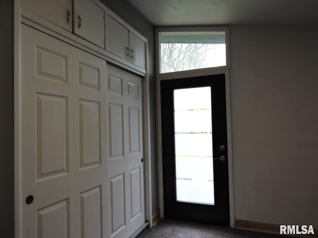entrance foyer with light carpet and plenty of natural light