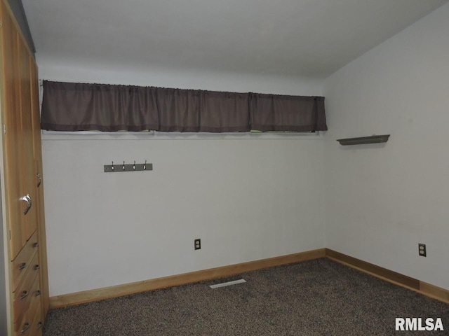 carpeted empty room with baseboards