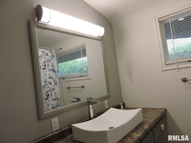bathroom featuring vanity and a shower with shower curtain