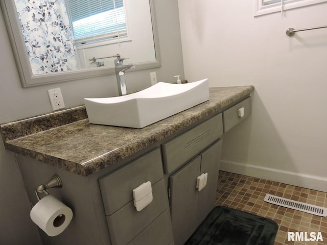 bathroom featuring baseboards and vanity