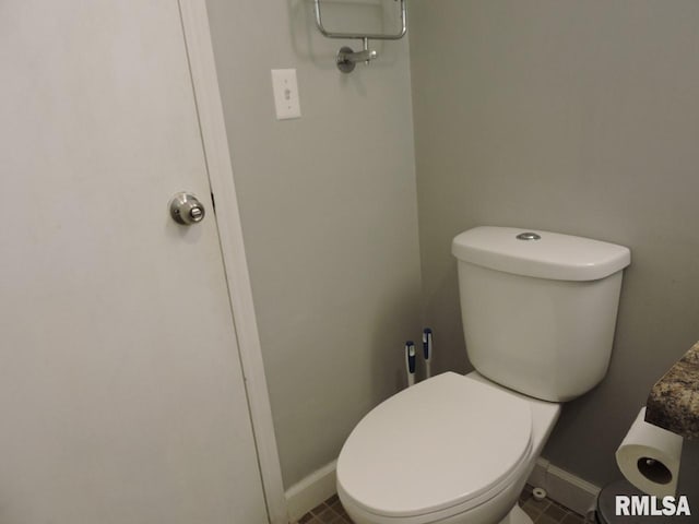 bathroom with toilet and baseboards