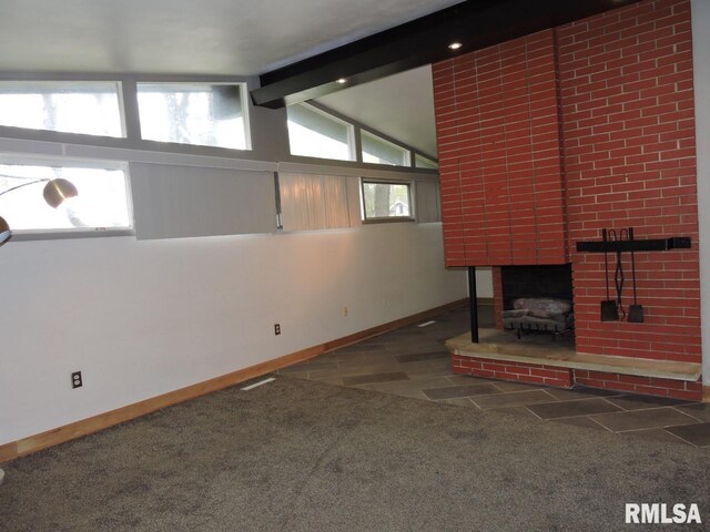 unfurnished living room featuring baseboards and carpet floors