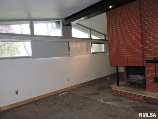 unfurnished living room featuring baseboards, a brick fireplace, plenty of natural light, and carpet flooring