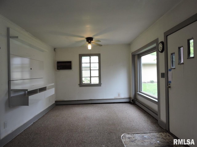 carpeted spare room featuring an AC wall unit, a baseboard radiator, plenty of natural light, and a ceiling fan