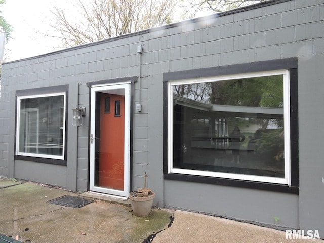 entrance to property with concrete block siding